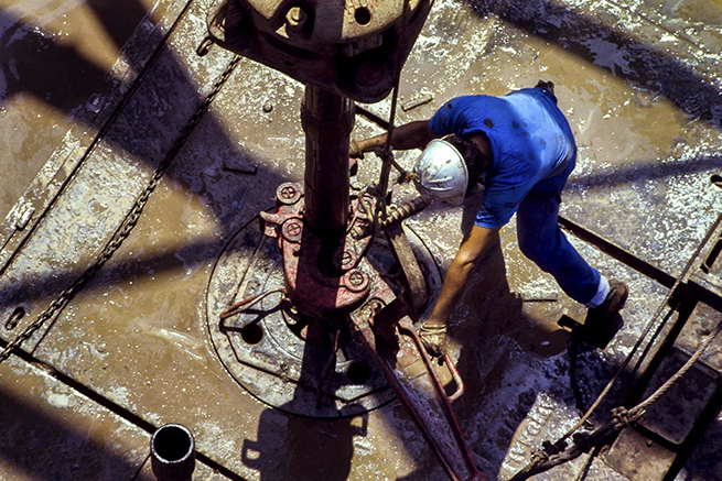 Man Standing on Drilling Shaft Equipement